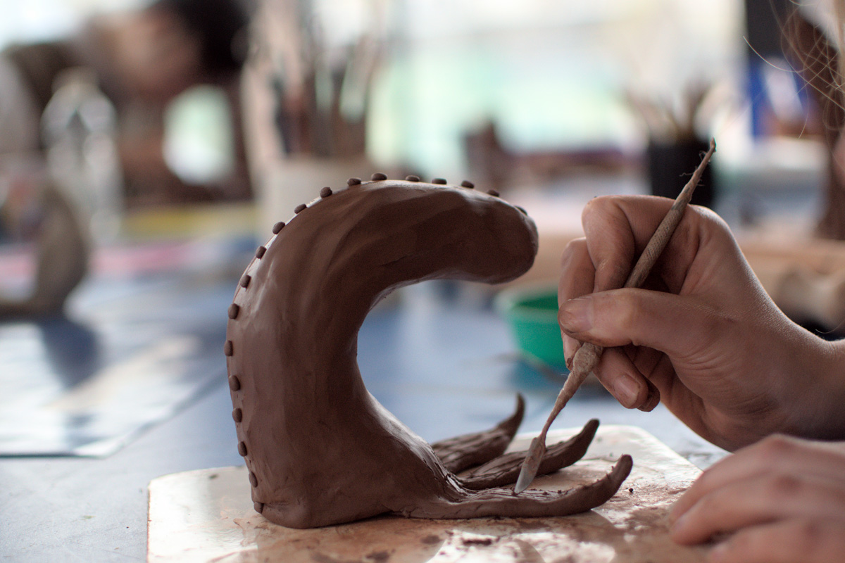 hands working with clay