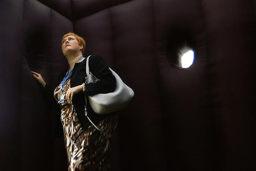women listening to sounds inside the inflatable prefab
