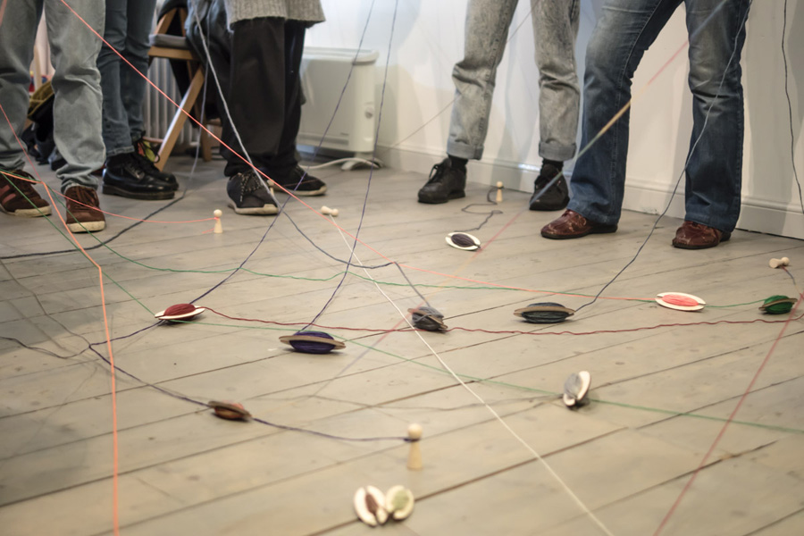 crypto knitting workshop participants throw spools in to common pool