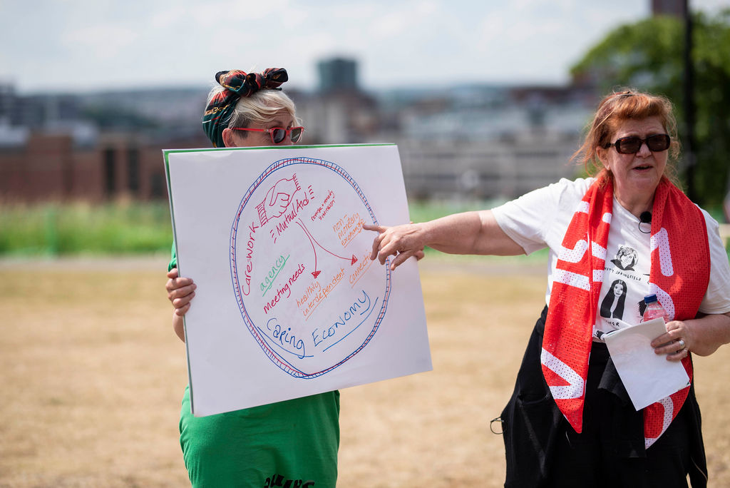 coaches showing team diagram for caring economy