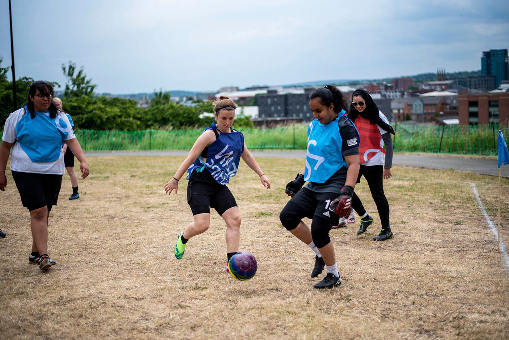 three teams play co-operative football in colourful geometric strips